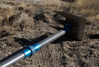 a shoveled shovel with a metal handle and a blue handle