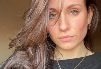 a woman with long hair and a necklace