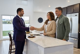 Lionel Bettinger Family reviewing purchase agreement in Harvest Ridge living room