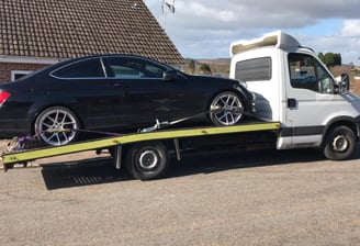 a car being towed by a tow truck