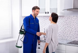 a professional pesticider worker shaking hands with a pesticider