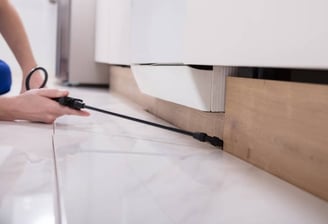 a person is using a cord cordless device to remove a kitchen floor