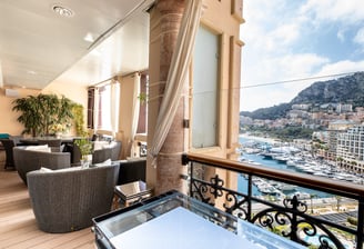 A balcony in Monaco with a view of the city and Monte Carlo harbour