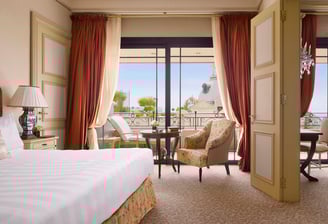 A luxurious suite bedroom at Hotel de Paris in Monaco