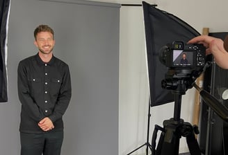 a man in a black shirt and a camera