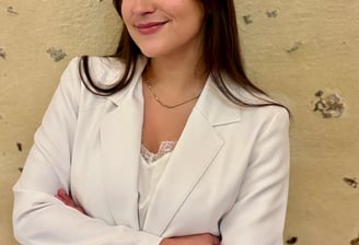 a woman in a white jacket and red skirt