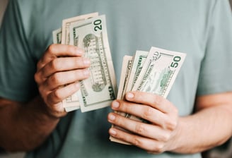 cash in someones hand for augusta precious metals fees