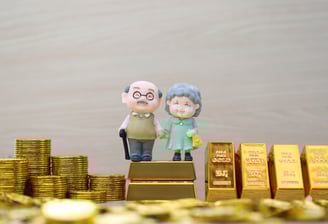 elderly couple with gold bars and coins for retirement