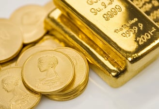 high quality gold bars and coins on white surface