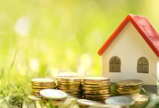 house with coins for real estate investing