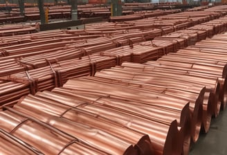 A variety of copper and metal pans are neatly hung on a store rack, alongside shelves filled with glassware and ceramic bowls. The setting appears to be a kitchenware shop with dim lighting, emphasizing the reflective surfaces of the pots and pans.