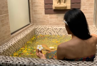 a woman in a bathtub with a flower in her hair