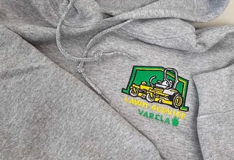 Gray hoodie with custom embroidered Lawn Service Varela logo featuring yellow lawn mower – business