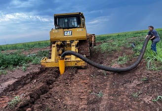 CAT D8T plowing in drain tile