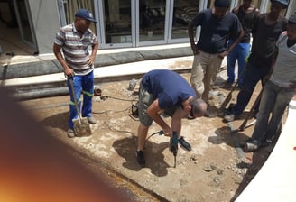 Slowly drilling of the slab to release trapped water for advanced waterproofing project, Sandton, Fredman Drive