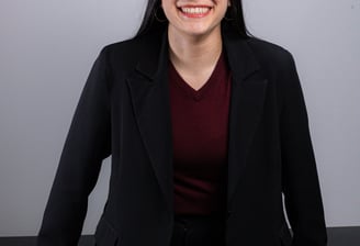 a woman in a black suit and red shirt