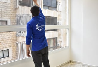 a man standing in front of a window with a window