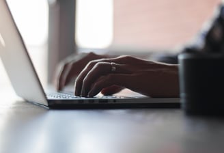 a person typing on a laptop computer