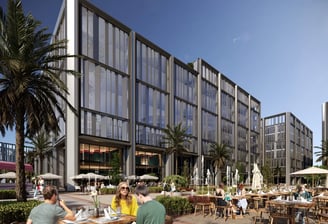 People enjoying outdoor dining at cafés beneath sleek office buildings at One Ninety, New Cairo.