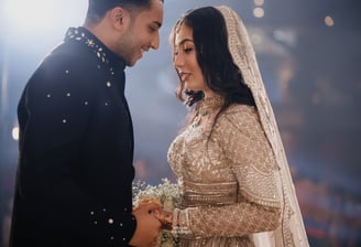 a bride and groom are standing in front of a crowd