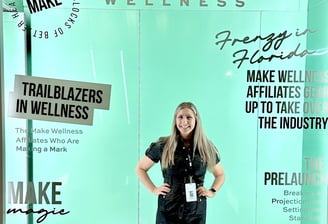 Woman posing with Make Wellness Magazine cover