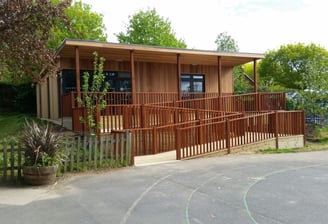 garden room for school with decking and balutrade