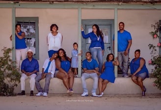 a family posing for a photo in front of a house