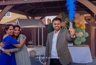 a man and woman standing in front of a party for baby shower