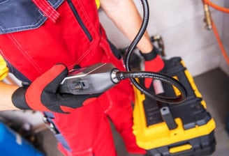 a plumber showing his advanced leak detector