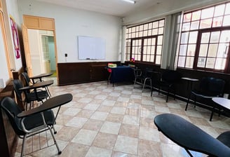 a room with chairs and tables and chairs