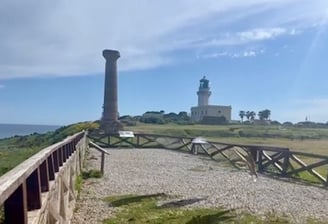 a lighthouse tower with a lighthouse in the background