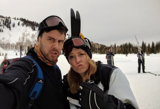couple making silly faces snow skiing