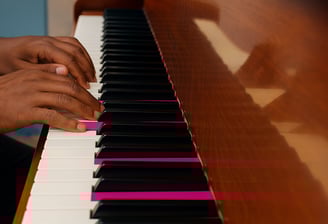 fingers of an african musician on the piano keys