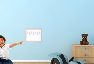 Child in a bedroom looking at the MagicBoard and NurtureIQ application