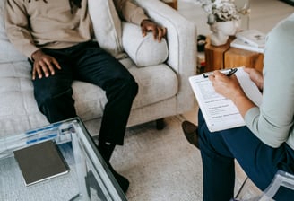 Person sitting down on a couch on therapy