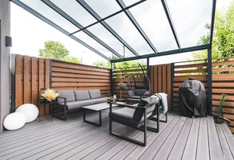 Modern custom deck with pergola and seating in outdoor living space in London Ontario