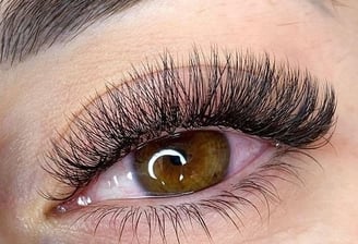 a woman with a large eyeliners and a pair of lashes
