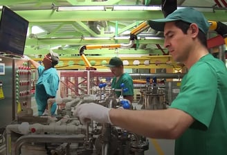 a man in a green shirt and white gloves