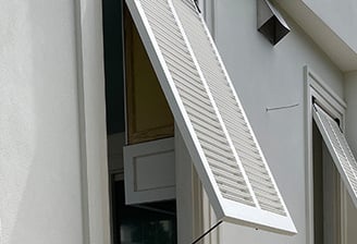 bahama shutters on an outdoor kitchen