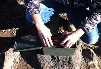 Steven opens a register box atop Black Mountain in Nevada