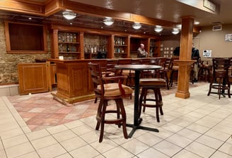 a bar with a bar stools near Decorah