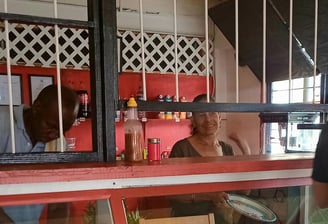 Owners of K.B. BABI restaurant inside their warm and inviting dinning space, offering a friendly atmosphere.