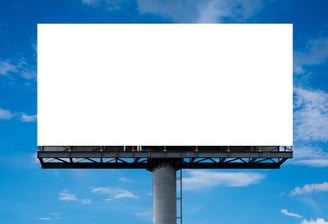 a billboard board with a blank white billboard on a cloudy day
