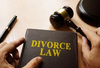 A divorce law book with pen and gravel