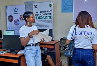 2 girls standing on opposite sides, with one having an inscription on the back of her shirt "DIGITPWD"