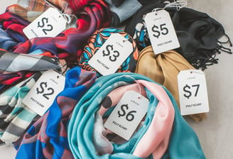 A photo of a variety of polyester scarves with affordable pricing