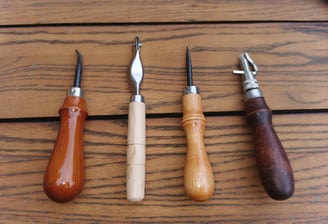 a set of four tools for leather crafting