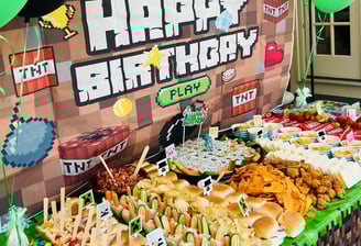 a table with a bunch of food and balloons