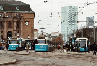 City tram and bus terminal with electric vehicles coordinated by public traffic control center.