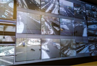 Centralized video wall displaying real-time highway surveillance footage for incident detection and response.